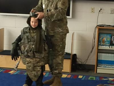Student trying on military attire